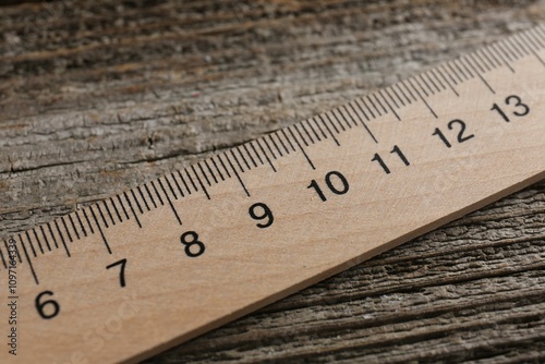 One ruler on wooden table, closeup view