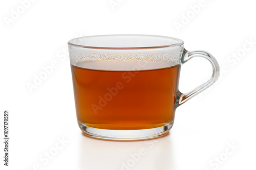 Warm beverage displayed in a clear glass mug on a minimalist background