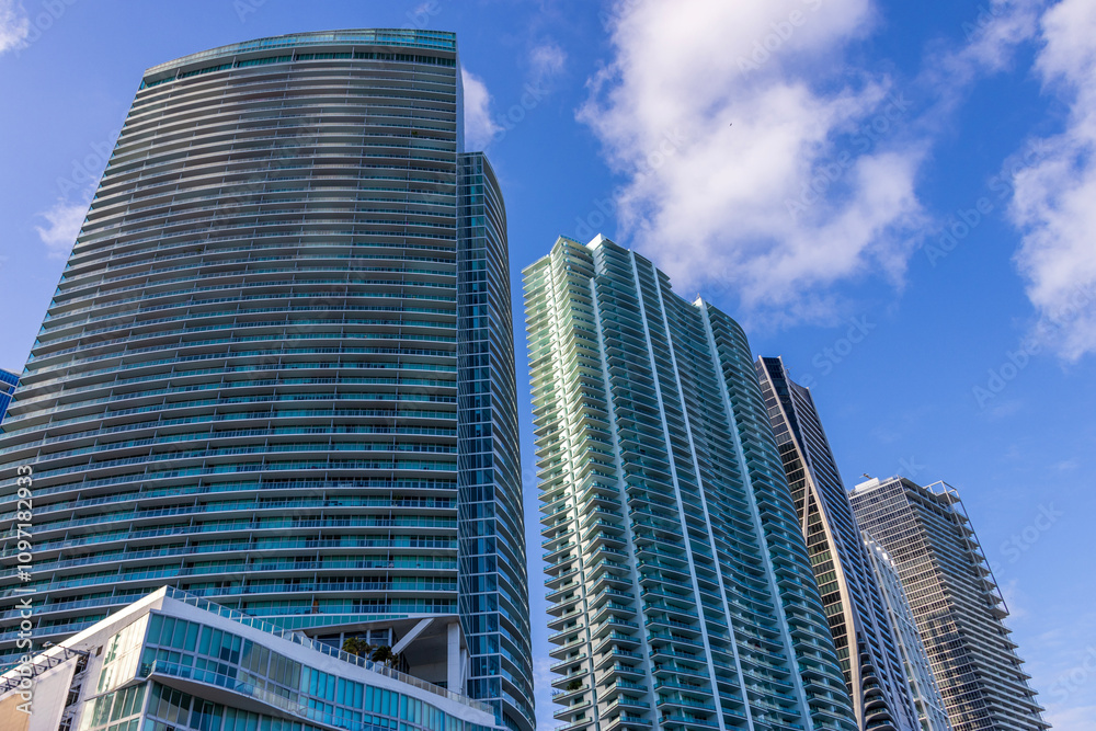 Skyscrapers, hotels and luxury condos in the city skyline at sunset with blue sky and clouds in Miami Florida USA Skyscrapers, hotels and luxury condos in the city skyline at sunset with blue sky and clouds in Miami Florida USA