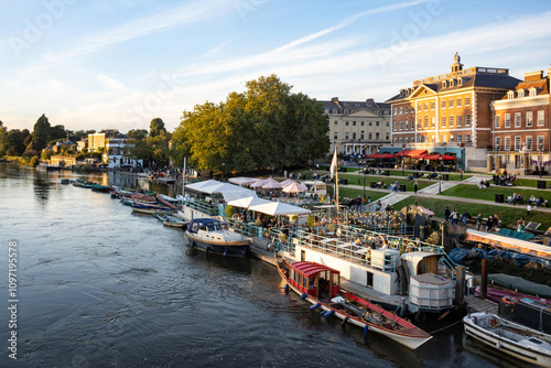 Richmond Upon Thames riverside area bustling with anonymised people in the early evening