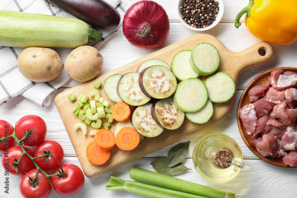 Cooking stew. Uncooked meat and vegetables on white wooden table, flat lay Cooking stew. Uncooked meat and vegetables on white wooden table, flat lay