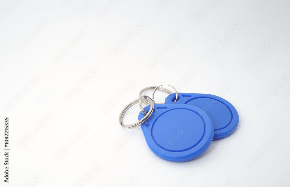 2 blue RFID (Radio Frequency Identification) keychain receivers on white background. Used by electronics, mechatronics, and networking engineers. 2 blue RFID (Radio Frequency Identification) keychain receivers on white background. Used by electronics, mechatronics, and networking engineers.