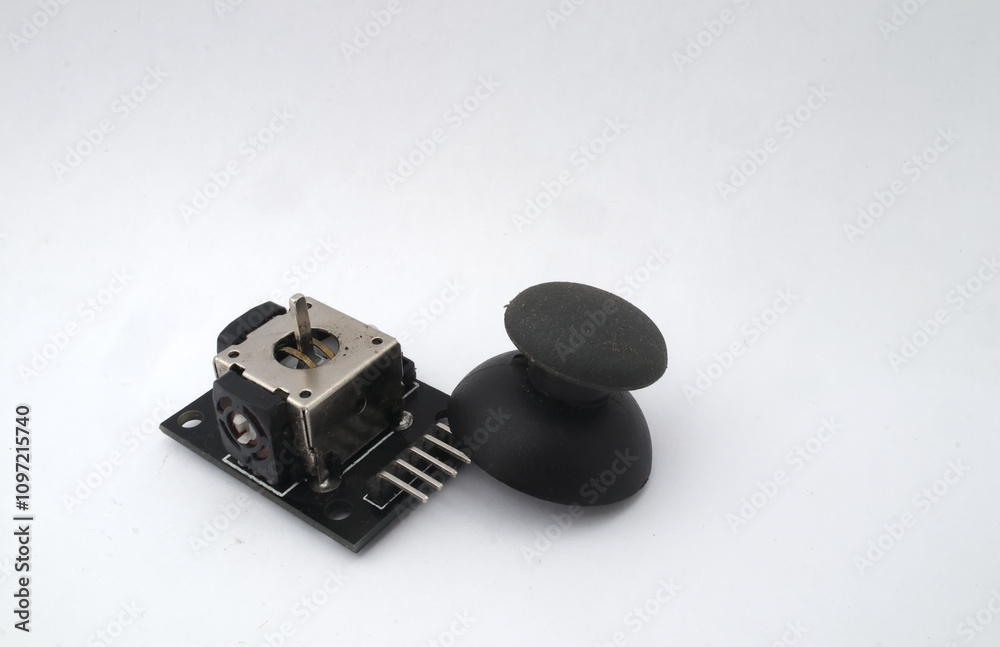 A joystick module with its rubber pads separated on a white background. Used for electronics and robotics enthusiasts. A joystick module with its rubber pads separated on a white background. Used for electronics and robotics enthusiasts.
