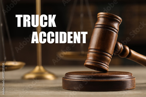 Truck accident law. Wooden judge's gavel and scales of justice on table