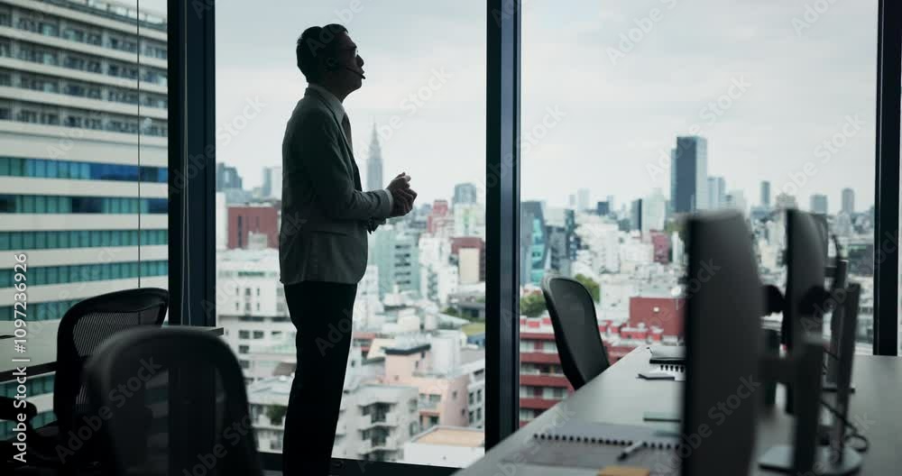 Businessman, headset and talking at window for advice, contact and conversation in office. Financial advisor, tech or discussion in Japanese agency for investment opportunity, problem solving or help Businessman, headset and talking at window for advice, contact and conversation in office. Financial advisor, tech or discussion in Japanese agency for investment opportunity, problem solving or help