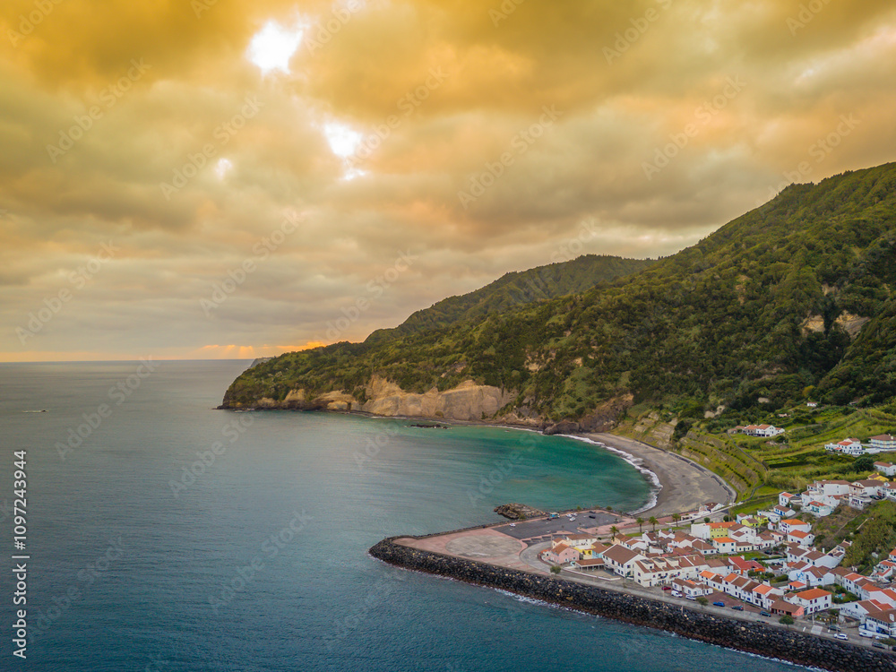 Obraz premium Aerial drone view of sunset over Azores islands. Ribeira Quente and Praia do Fogo. Landscape of Sao Miguel coastline with green mountains in Azores