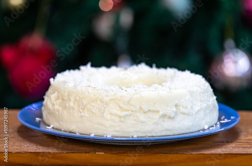 Traditional Brazilian coconut flan dessert known as manjar branco, manjar de coco and manjar dos deuses. Served with plum syrup. photo