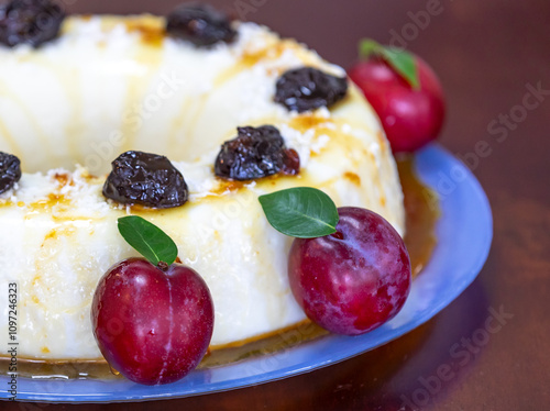 Traditional Brazilian coconut flan dessert known as manjar branco, manjar de coco and manjar dos deuses. Served with plum syrup. photo