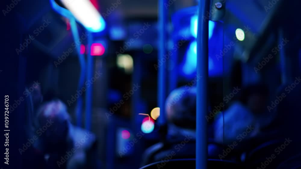 People sitting in a moving train in the evening with blue lighting