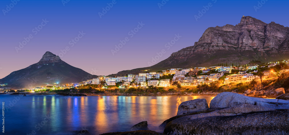 Illuminated Lion's Head, Camps Bay, and Bakoven with lights reflecting on the Atlantic Ocean, panorama shot, Cape Town, South Africa