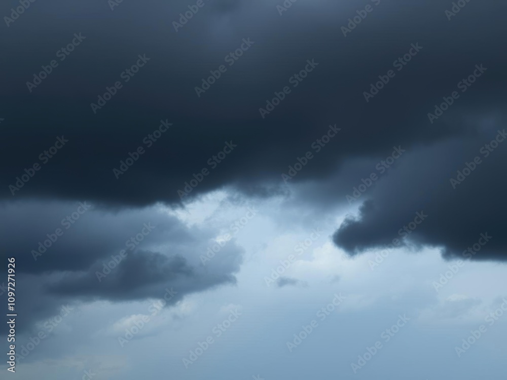Dark, ominous sky filled with heavy black clouds just before a thunderstorm, gloomy, impending