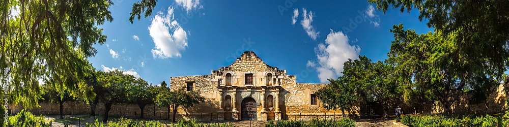 San Antonio Alamo: The iconic Alamo mission in San Antonio, surrounded by lush greenery and a crisp blue sky. San Antonio Alamo: The iconic Alamo mission in San Antonio, surrounded by lush greenery and a crisp blue sky.