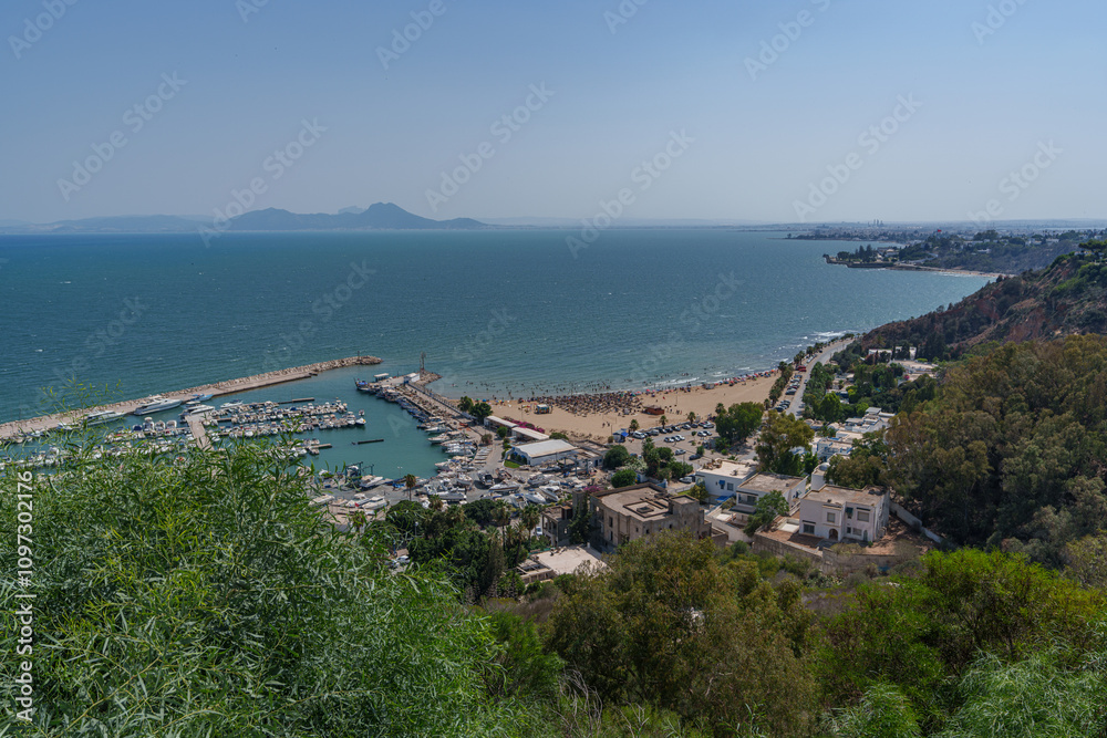 Panorama seen from a high mountain over the sea with a small port and beach Panorama seen from a high mountain over the sea with a small port and beach