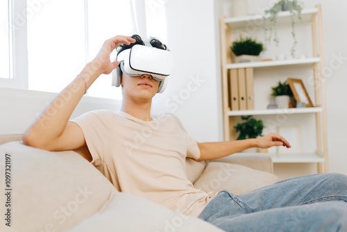 Virtual reality experience, young man using VR headset, digital technology concept, modern living room with bright colors, immersive entertainment environment, engaging leisure activity