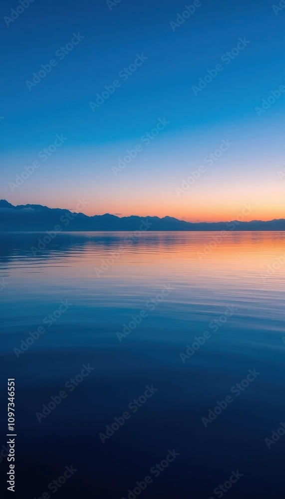 view of a calm lake with mountains in the distance view of a calm lake with mountains in the distance