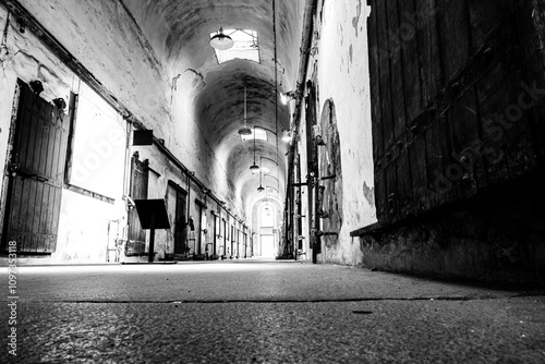 Quadro em tela Floor level point of view of a lit cellblock of Eastern State Penitentiary historic site