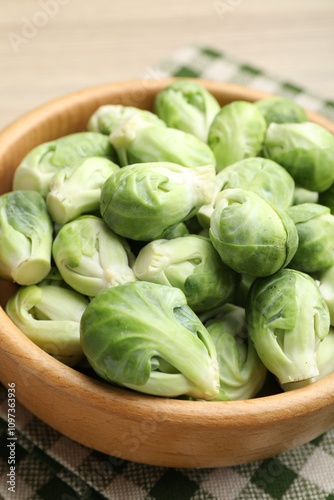 Fresh green Brussels sprouts in bowl on table, closeup