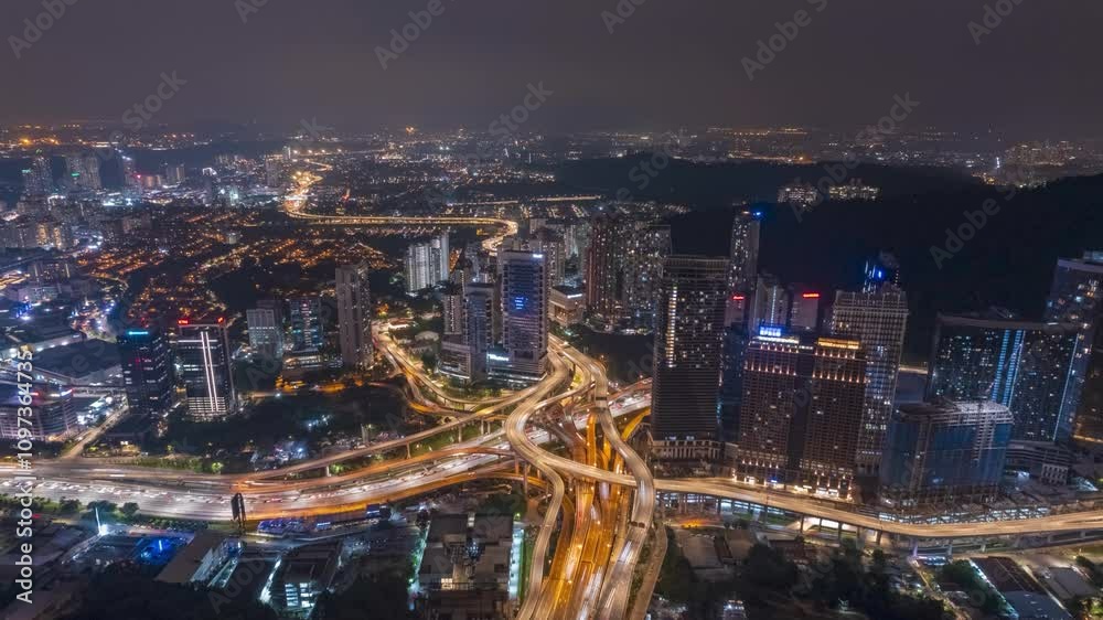 A sprawling metropolis at night, illuminated by the glow of countless lights. The intricate highway network weaves through the cityscape. A sprawling metropolis at night, illuminated by the glow of countless lights. The intricate highway network weaves through the cityscape.