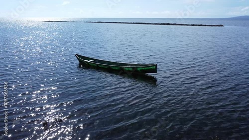 Small boat on the ocean in the early morning light.