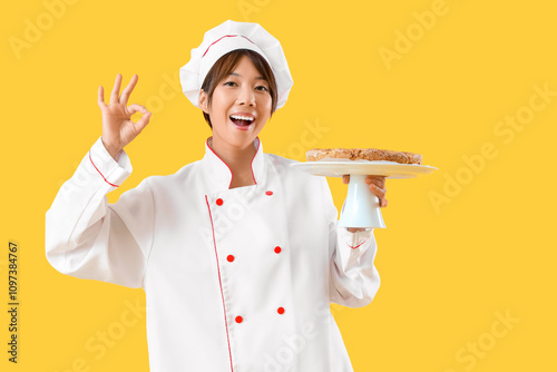 Female Asian chef with tast...