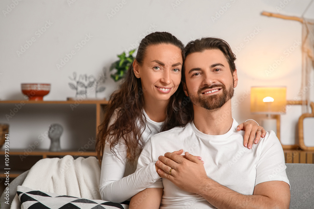 Happy wife hugging her husband at home Happy wife hugging her husband at home