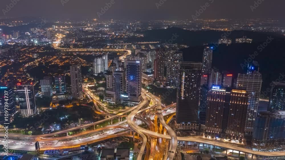 A sprawling metropolis at night, illuminated by the glow of countless lights. The intricate highway network weaves through the cityscape. A sprawling metropolis at night, illuminated by the glow of countless lights. The intricate highway network weaves through the cityscape.