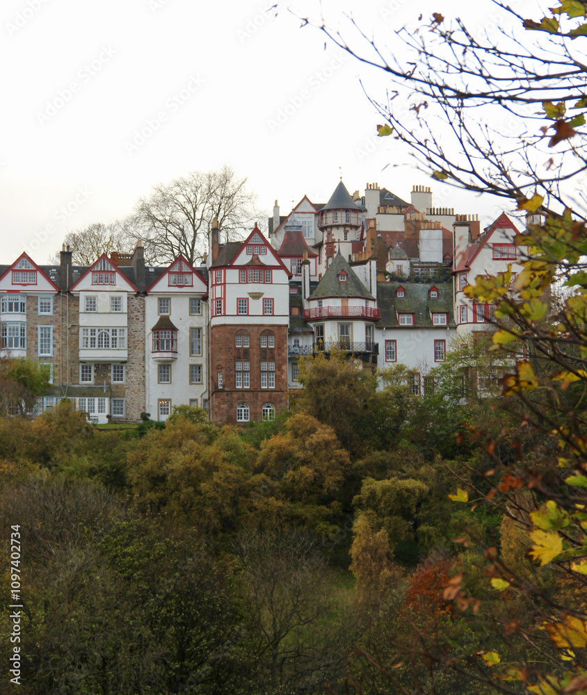town houses in edinburgh with lush greenery in the forefront and a white sky town houses in edinburgh with lush greenery in the forefront and a white sky