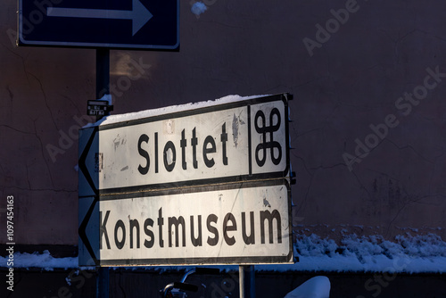 Uppsala, SwedenA road sign downtown pointing towards the Castle, Slottet, and the Art Msueum, Konst Museum. photo