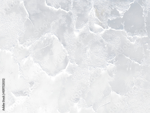 Close-up of dark, peeling paint on a textured surface.