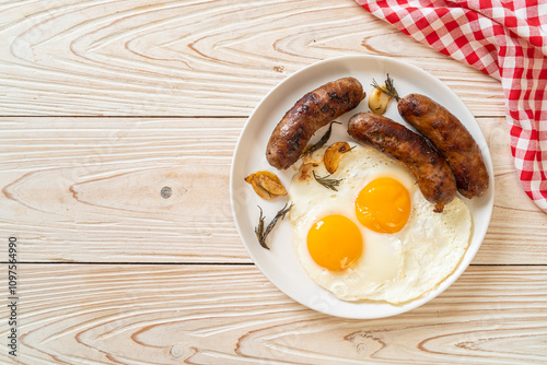 double fried egg with pork sausage photo