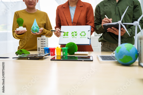 Asian business professionals discuss waste management and recycling strategies at desk, focusing on clean energy initiatives solar panels, electric cars, zero-waste solutions for sustainable future. photo