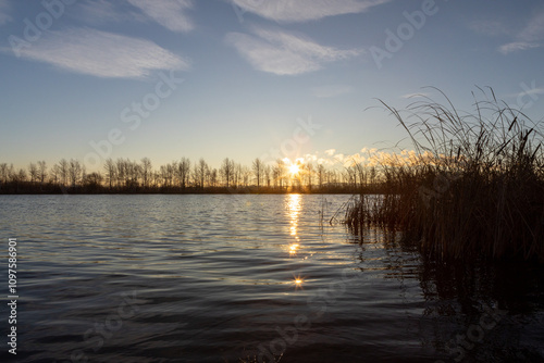 The beauty of the autumn Lake at sunrise with the rays of the sun