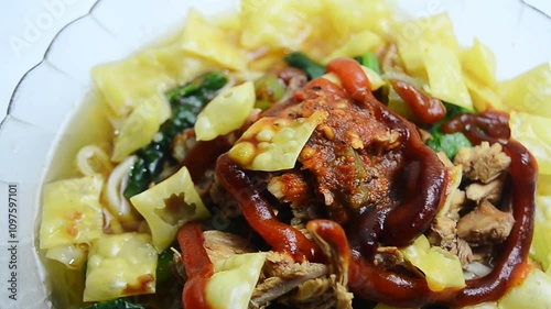 shot on chicken noodles, a typical Indonesian dish made from wheat noodles seasoned with pieces of chicken meat. This dish is heavily influenced by Chinese culinary presentations.