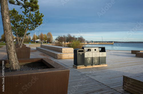 Bild auf Leinwand General waste and recycle rubbish bins on the wooden embankment recreation area
