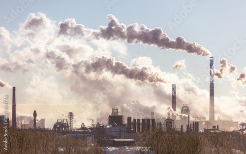 A city skyline with a large cloud of smoke coming from a factory photo