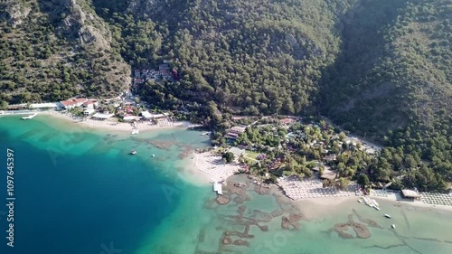 Turkey,Fethiye,Oludeniz,Dead Sea's drone footage starts from the lagoon side and moves slowly towards to the Belcekiz beach on a sunny day.Beautiful turquoise waters and the white sand beach. photo