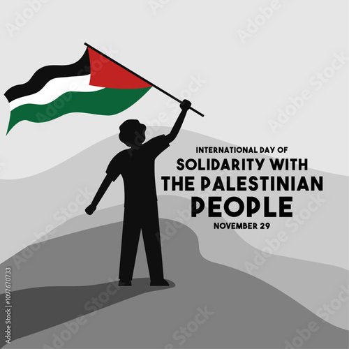 International Day of Solidarity With The Palestinian People. November 29. A person stands waving a Palestinian flag.