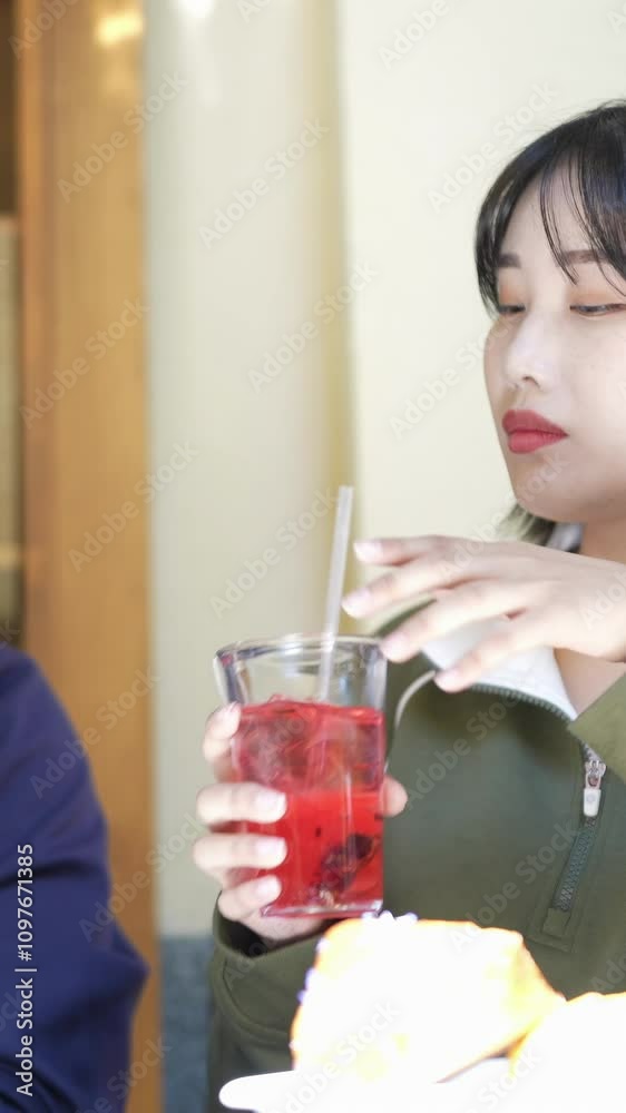 A couple, a Korean man in his 30s and a woman in her 20s, wear tracksuits and enjoy an afternoon at a nice Western-style cafe in Seoul, South Korea. Vertical video. A couple, a Korean man in his 30s and a woman in her 20s, wear tracksuits and enjoy an afternoon at a nice Western-style cafe in Seoul, South Korea. Vertical video.