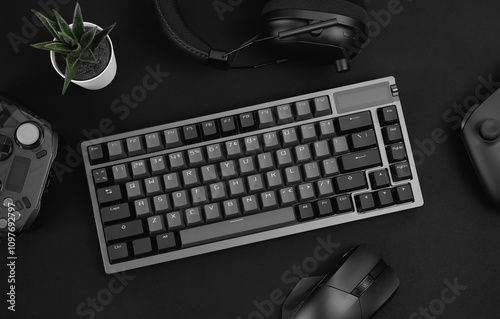 gamer work space concept, top view a gaming gear, mouse, keyboard, joystick on black table background.