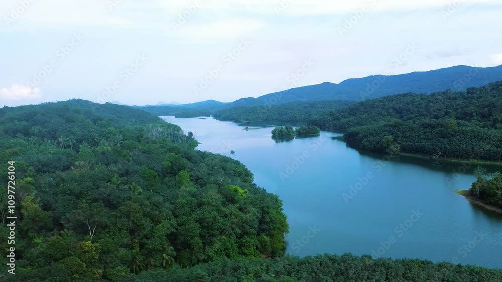 Areal view of a Beautiful reservoir dam in Kerala, India, Morning view of Neyyar dam, Mountains and small green islands are seen in this video Areal view of a Beautiful reservoir dam in Kerala, India, Morning view of Neyyar dam, Mountains and small green islands are seen in this video
