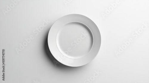 a close up of a white plate on a white surface photo