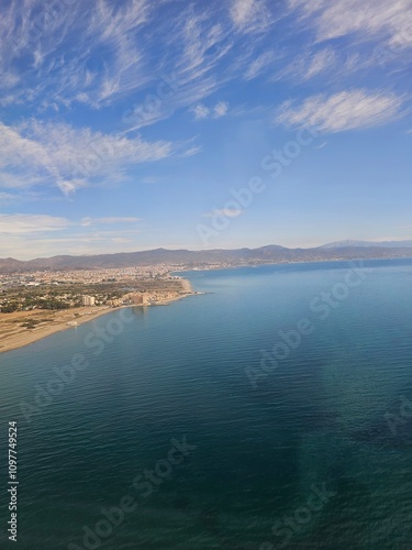 Spain, October 09, 2024: High flight in the mountains of the spanish coast. Aerial drone view to the cities, seaside and mountains. Beautiful landscape from the clouds.