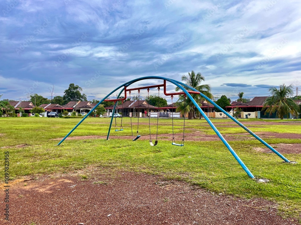 A vibrant playground with swings, slides, and seesaws in a lush residential park, surrounded by shady trees and clean walking paths. A vibrant playground with swings, slides, and seesaws in a lush residential park, surrounded by shady trees and clean walking paths.