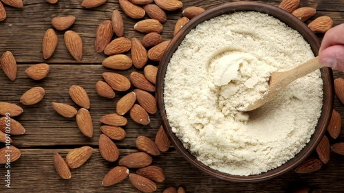 Fresh almond flour in a bowl and almonds. Gluten free food concept.