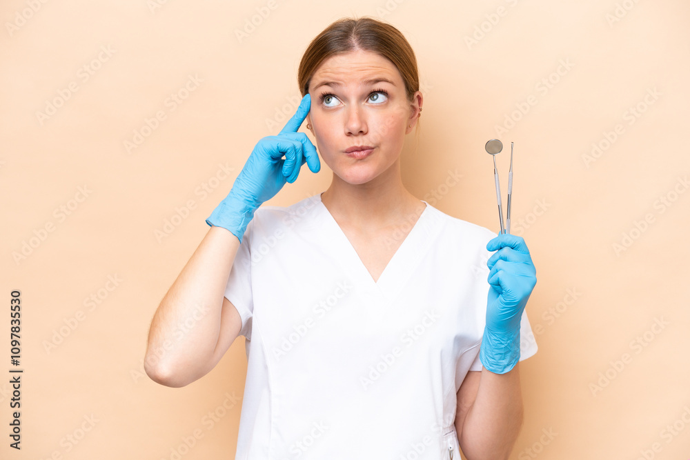 Dentist caucasian woman holding tools isolated on beige background having doubts and thinking Dentist caucasian woman holding tools isolated on beige background having doubts and thinking