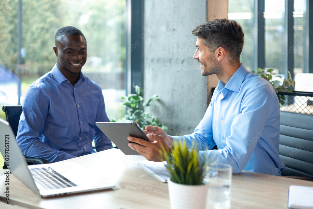 Two business men talking to each other discussing their business proposal. Two business men talking to each other discussing their business proposal.