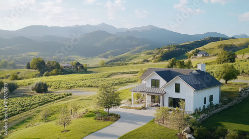 Aerial view of craftsman style farmhouse among vineyard fields