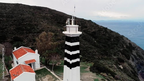 Sarpincik Historical Lighthouse, Izmir - High quality video of Izmir Sarpincik Lighthouse taken from the air with a drone on a cloudy day photo