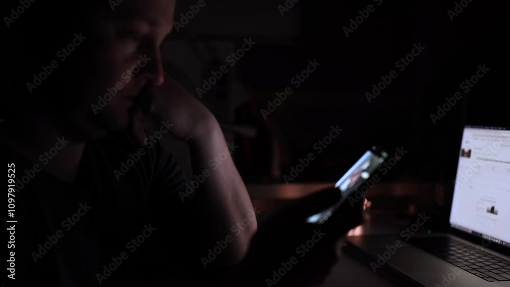 A man deeply engaged in his phone, illustrating the phenomenon of social media overconsumption. scrolling social media A man deeply engaged in his phone, illustrating the phenomenon of social media overconsumption. scrolling social media