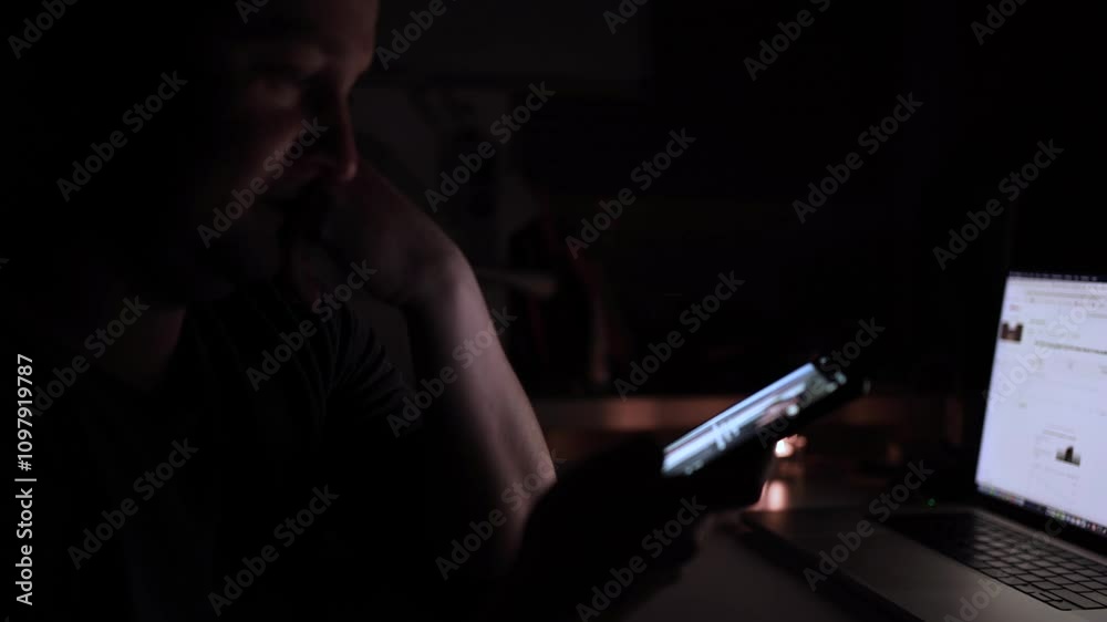 A man deeply engaged in his phone, illustrating the phenomenon of social media overconsumption. scrolling social media A man deeply engaged in his phone, illustrating the phenomenon of social media overconsumption. scrolling social media